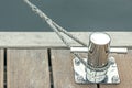 Blue toned marina bollard with rope. Royalty Free Stock Photo