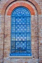 Blue Toned Stained Glass Window on Old Sandstone Church Royalty Free Stock Photo