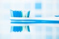 Blue toothbrush in a bathroom with reflection Royalty Free Stock Photo