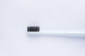 Blue toothbrush with black bristles on a white background. Close-up Royalty Free Stock Photo