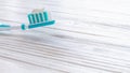 Blue toothbrush on a wooden surface with toothpaste. Background. Copy space Royalty Free Stock Photo