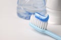 Blue toothpaste on a toothbrush on white background Royalty Free Stock Photo