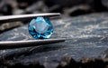 Blue topaz gemstone jewelry photo with black stone and dark lighting Royalty Free Stock Photo