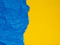 Blue torn and crumpled paper on a yellow background Royalty Free Stock Photo