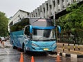 Blue Tour Bus Parked Beside The Sidewalk in Jakarta City Royalty Free Stock Photo