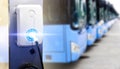 Blue tourist buses on parking and Power supply for electric car charging. Electric car charging station. EV Car battery charger at Royalty Free Stock Photo