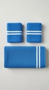 Blue towels arranged on a light gray surface. The setup includes one large towel and tw Royalty Free Stock Photo
