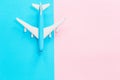 Blue toy airplane on blue and pink background Royalty Free Stock Photo