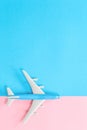 Blue toy airplane on blue and pink background Royalty Free Stock Photo