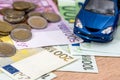 Blue toy car with euro bills Royalty Free Stock Photo