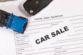 Blue toy car, key and form of vehicle sales agreement. Inscription car sale. Sales and buying new or used car Royalty Free Stock Photo