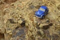 Blue toy car on mountain. Royalty Free Stock Photo