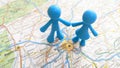 A blue toy figure couple standing on a map of Munich Germany
