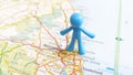 A blue toy figure standing over Newcastle Upon Tyne on a map of England portrait Royalty Free Stock Photo