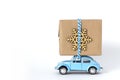 Blue toy retro car carries on a roof a Christmas gift Royalty Free Stock Photo