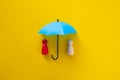 Blue toy umbrella and wooden doll figures