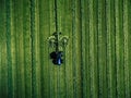 Blue tractor mowing green field, aerial view Royalty Free Stock Photo