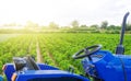 Blue tractor in a paprika pepper plantation field. Farming and agricultural industry. Cultivation and care of plants. Agricultural Royalty Free Stock Photo