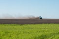 Blue tractor plowing field Royalty Free Stock Photo