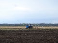 Tractor working in spring field, Lithuania Royalty Free Stock Photo