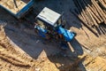 A blue tractor sits parked on bare dirt, ready for construction work Royalty Free Stock Photo