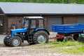 Blue tractor with trailer on the farm Royalty Free Stock Photo