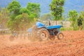 Blue tractor work on the field. Royalty Free Stock Photo