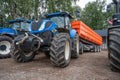 Blue tractors with orange trailers. Royalty Free Stock Photo