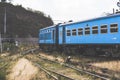 Blue train along mountains Royalty Free Stock Photo