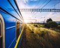 Blue train moving in a picturesque summer landscape Royalty Free Stock Photo