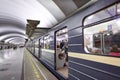 Blue train with passengers standing near platform to subway stat Royalty Free Stock Photo