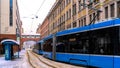 Blue tram rides around town, transport