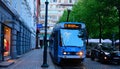 Blue tram stopping near Alle Tiders shop on Stortorvet street.