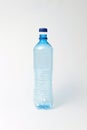 Blue transparent bottle for water on a light background. Mock up. Royalty Free Stock Photo