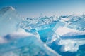 Blue transparent ice floes on Baikal lake at sunset. Selective focus. Winter landscape