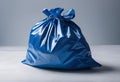 Blue trash bag on a white surface, AI-generated. Royalty Free Stock Photo