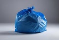 Blue trash bag on a white surface, AI-generated. Royalty Free Stock Photo