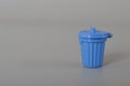 Blue trash can isolated on a grey background. Copy space for the text Royalty Free Stock Photo
