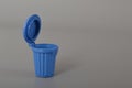 Blue trash can isolated on a grey background. Copy space for the text Royalty Free Stock Photo