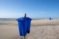 Blue trash cans dustbin on an empty beach Royalty Free Stock Photo