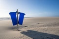 Blue trash cans dustbin on an empty beach Royalty Free Stock Photo
