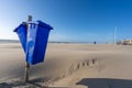 Blue trash cans dustbin on an empty beach Royalty Free Stock Photo