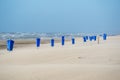 Blue trash cans dustbin on an empty beach Royalty Free Stock Photo