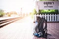 Blue Travel backpack put recline wooden bench in Ayutthaya train station