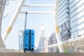 Blue travel bag on walkway with blurred city background