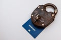 Blue travel passport locked to padlock with key on a white background. Coronavirus and travel concept Royalty Free Stock Photo