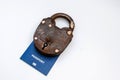 Blue travel passport locked to padlock on a white background. Coronavirus and travel concept Royalty Free Stock Photo