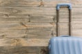 blue travel suitcase against wooden background. High quality photo Royalty Free Stock Photo