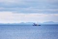 Blue trawler fishing boat sailing over the calm sea Royalty Free Stock Photo