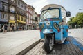 Blue tricycle waiting for tourist on the street of Porto, Portugal